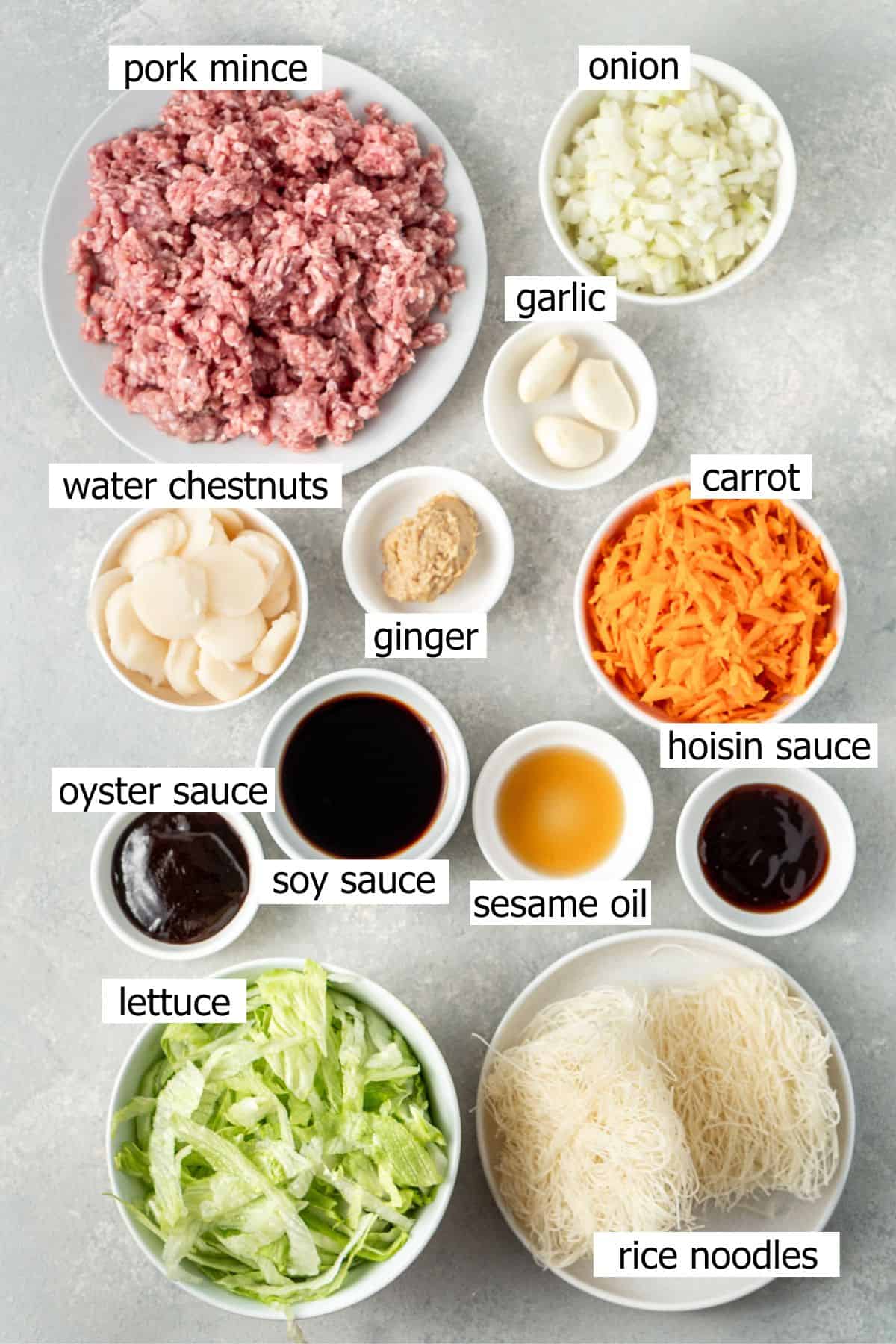 All ingredients needed to make san choy bow bowls laid out in small bowls.