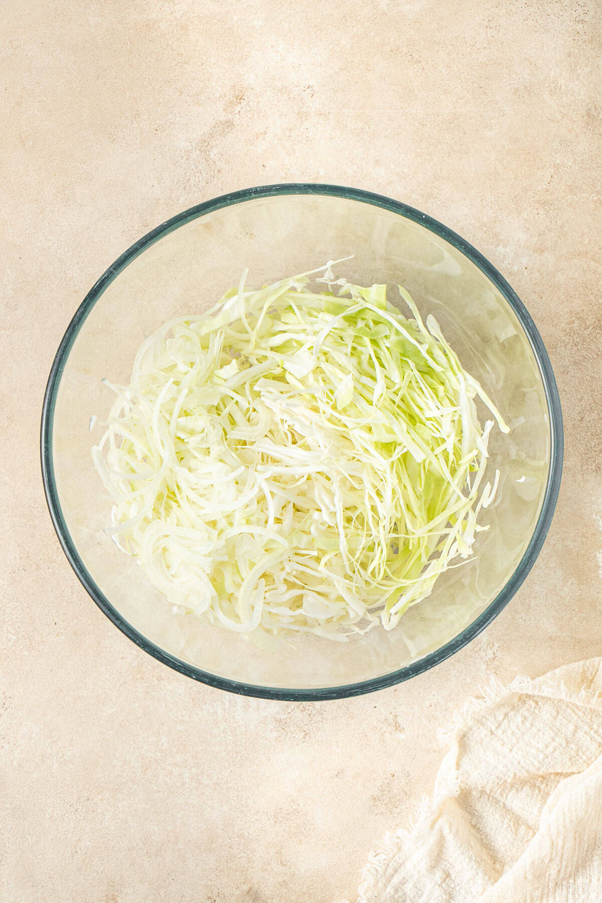 Shredded cabbage in a glass bowl.