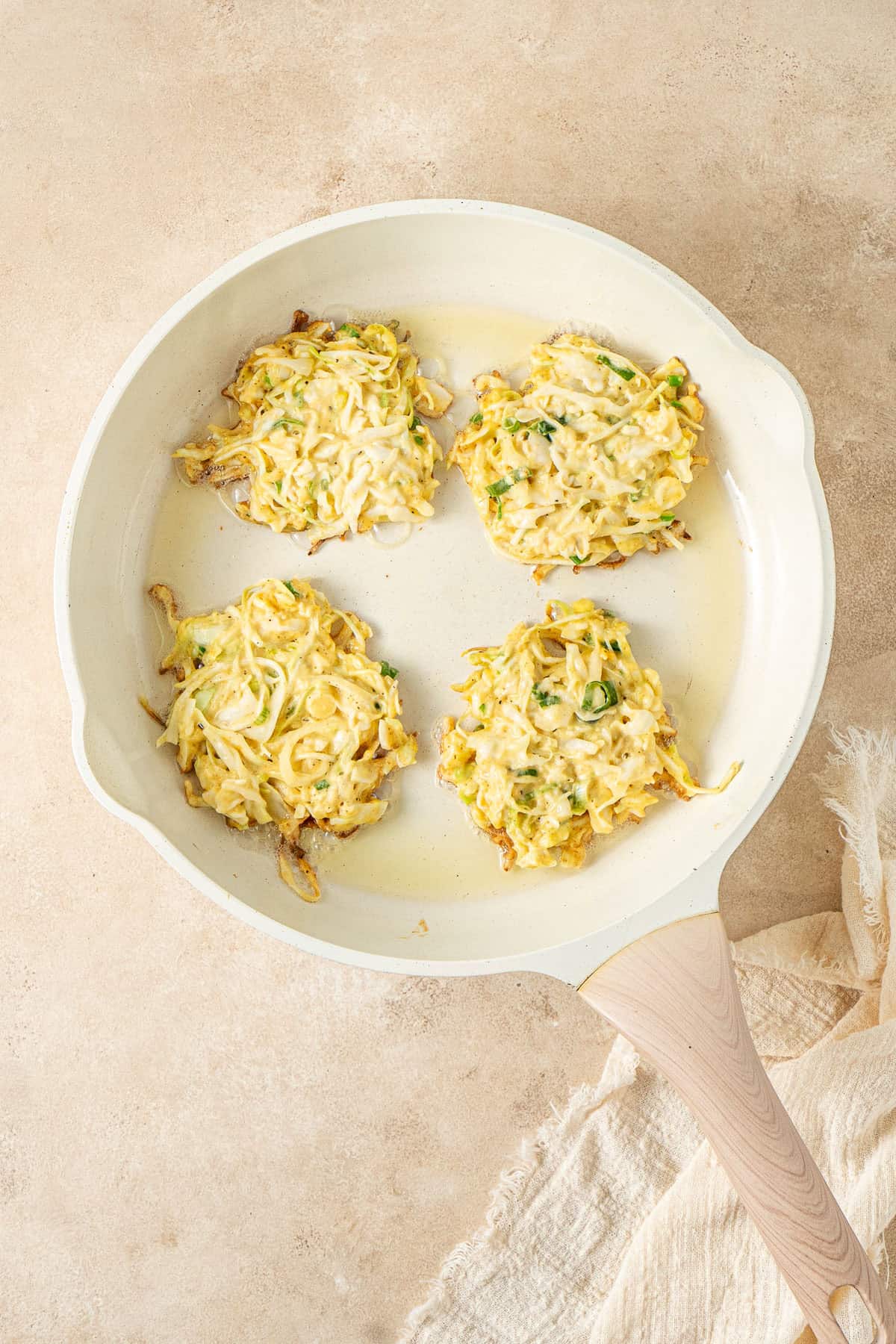 The fritters in a frying pan.