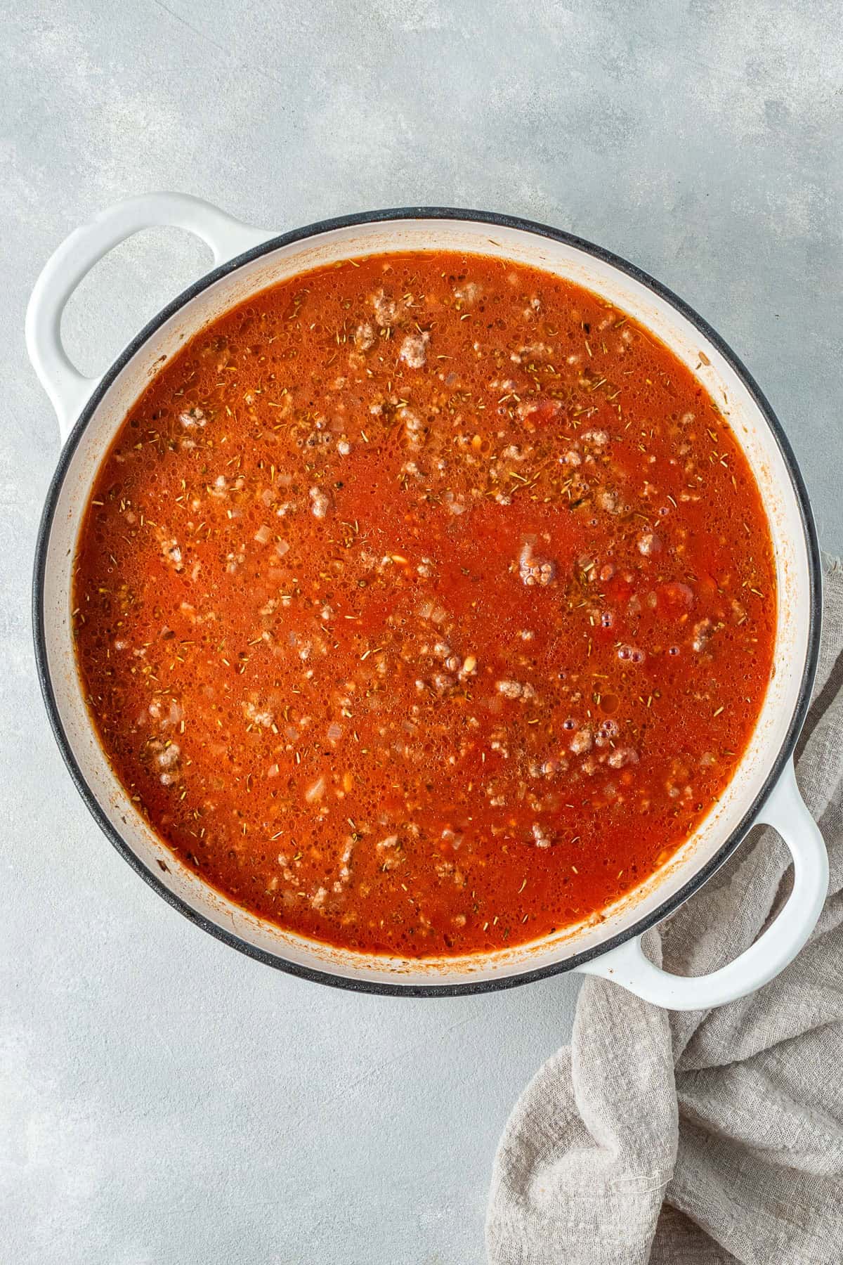 Adding the liquid to the pan with the beef.