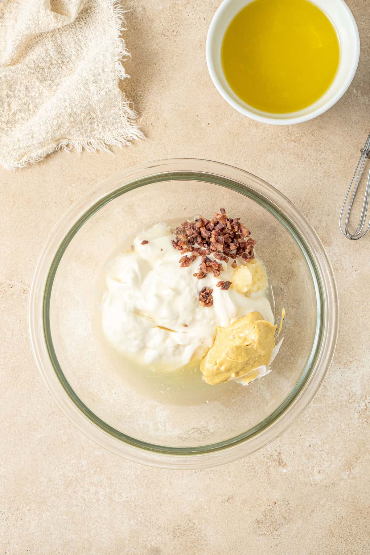 Mixing together the caesar salad dressing ingredients in a small bowl.