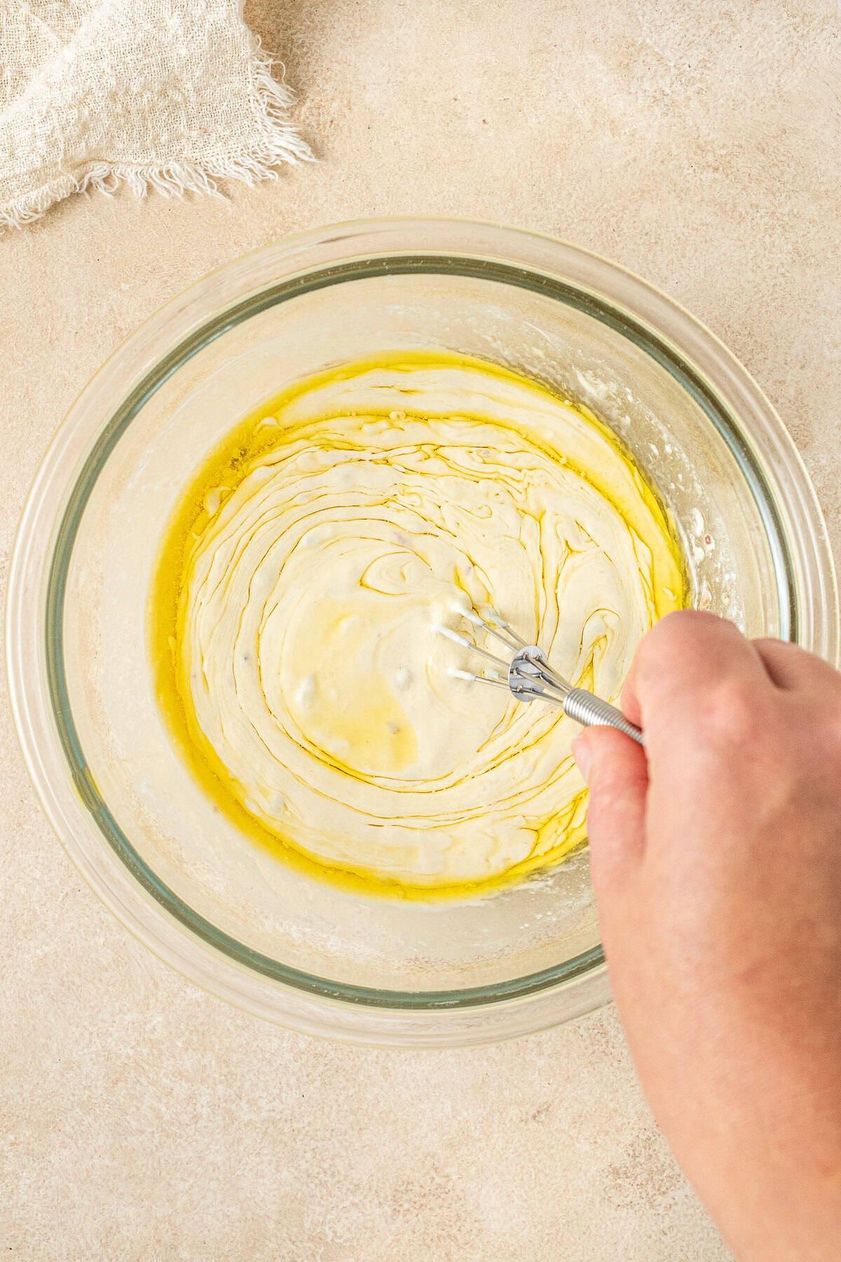 Whisking in the oil to the dressing in a small bowl.