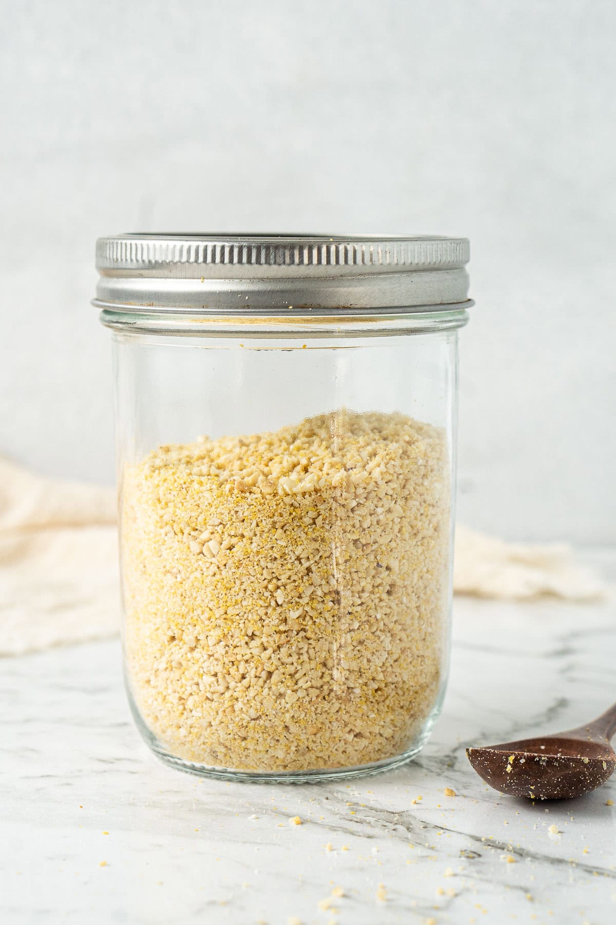 The vegan parmesan in a jar with a lid.