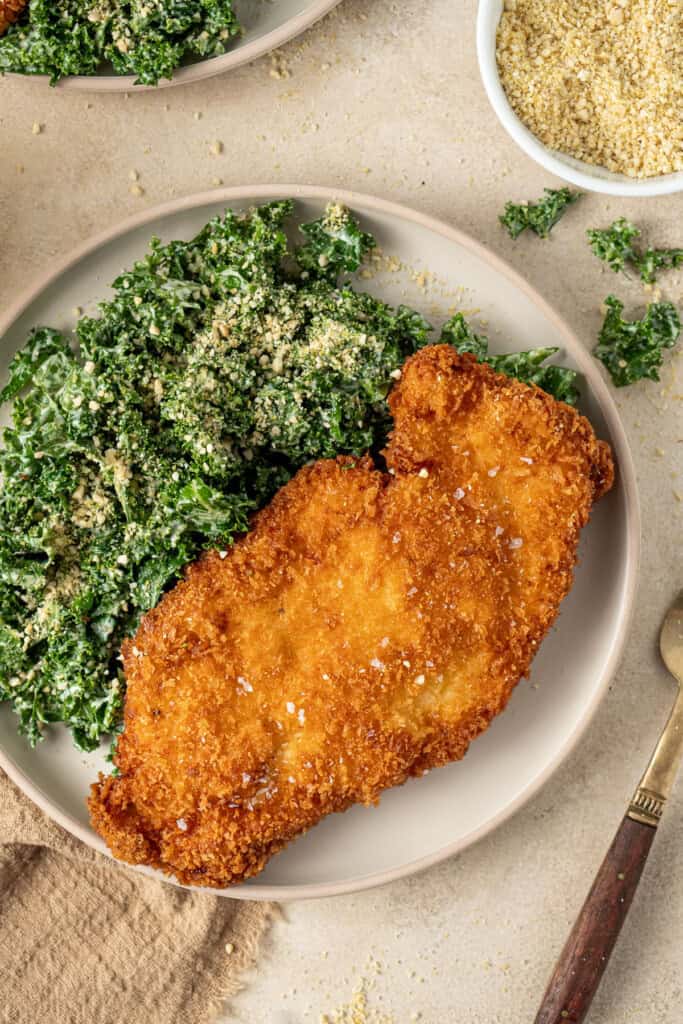 A chicken schnitzel and dairy free kale caesar salad.