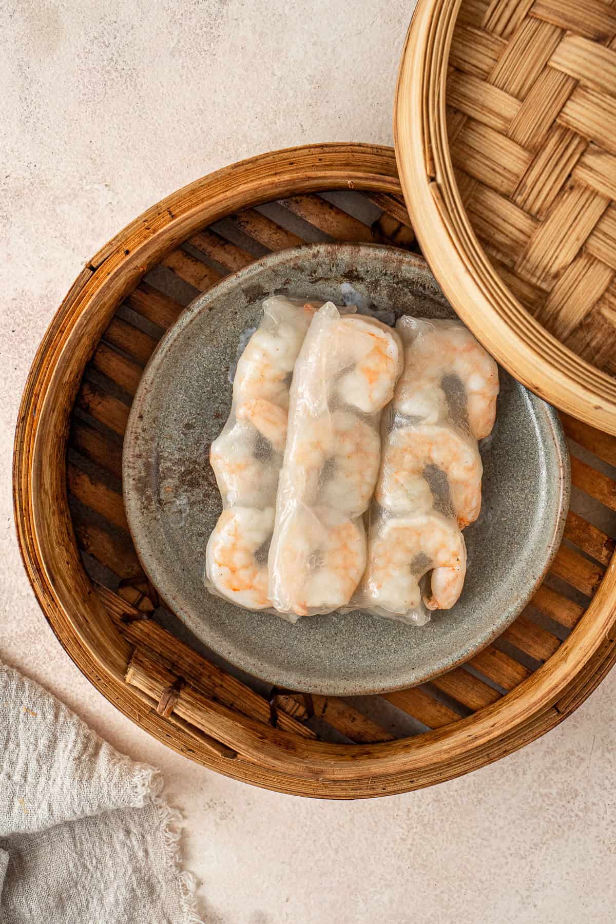 Steaming the rolls on a plate in a bamboo basket. 