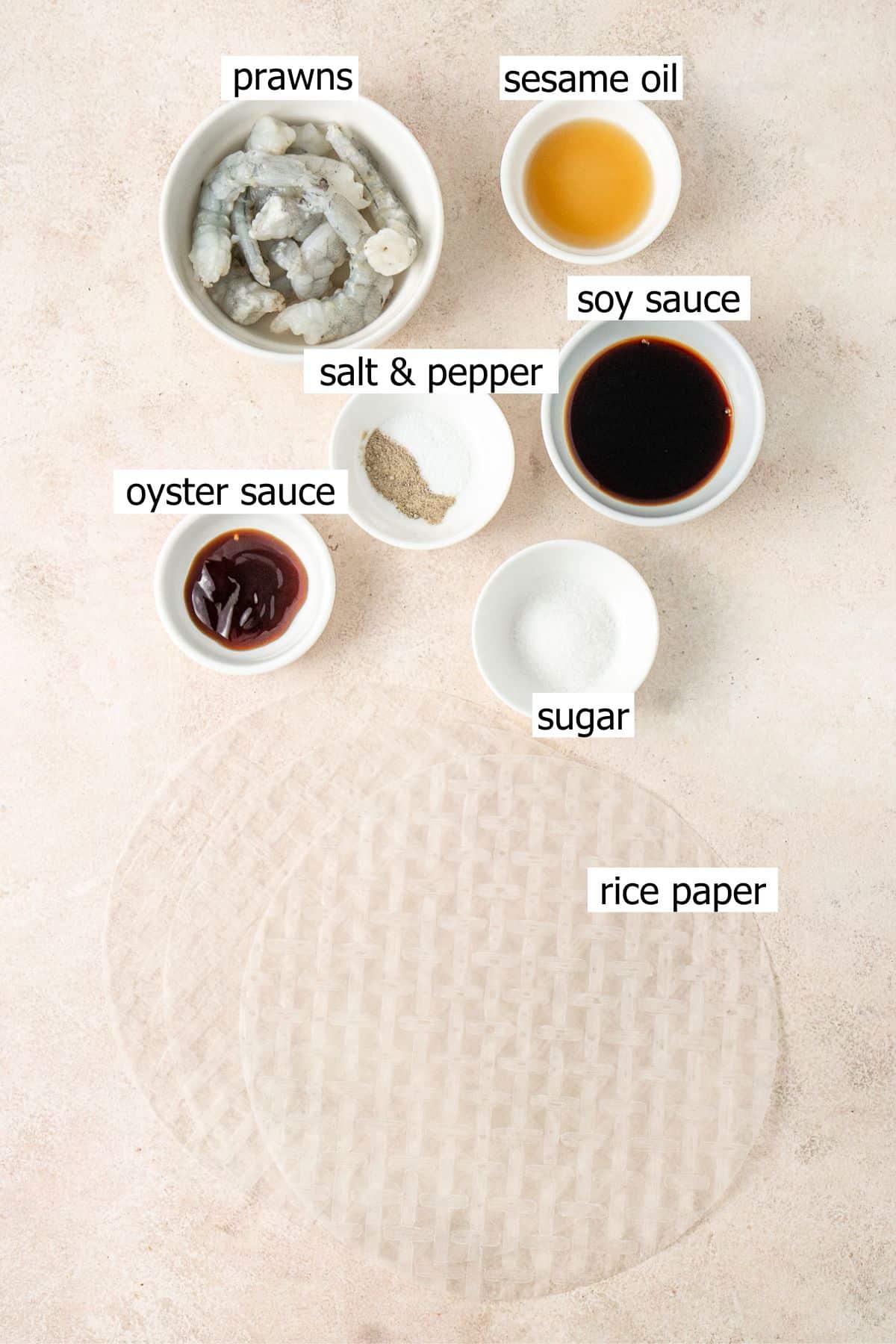 All ingredients needed to make steamed prawn rice paper rolls laid out in bowls.