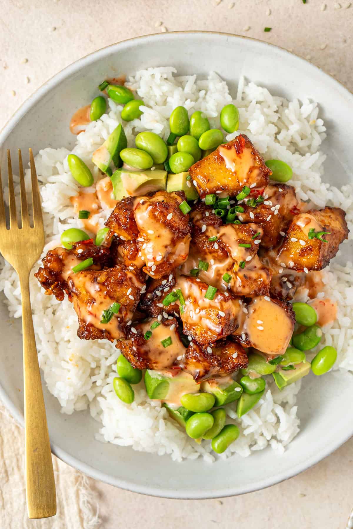 Close up of the bang bang tofu served over vegetables and rice.