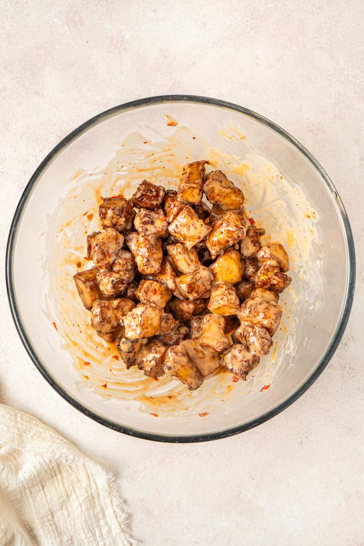 The crispy tofu in a bowl tossed with bang bang sauce.