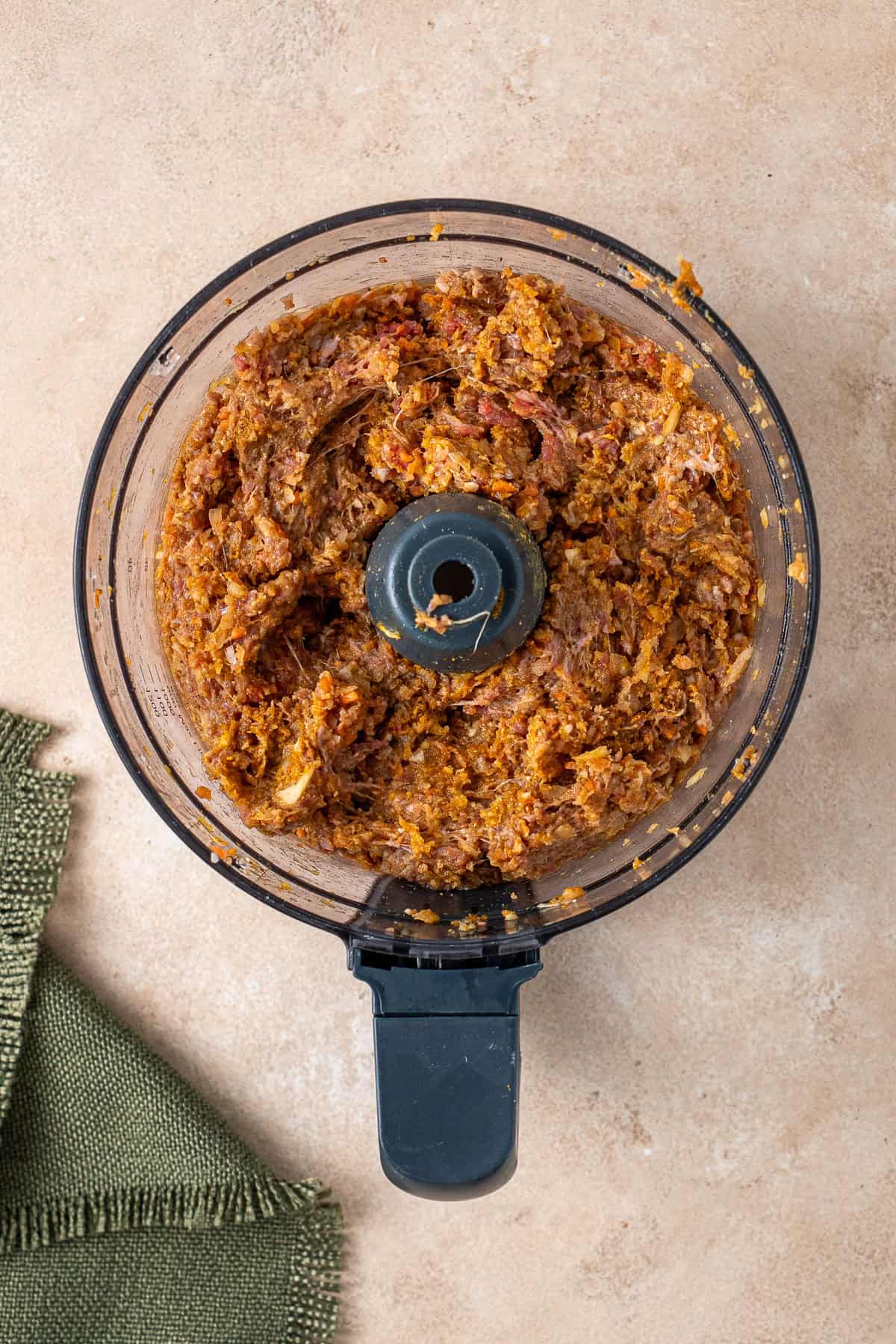 The beef sausage roll filling in a food processor.
