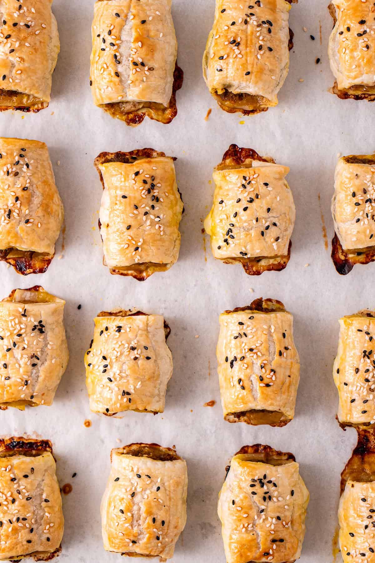 The cooked beef sausage rolls on a baking tray.