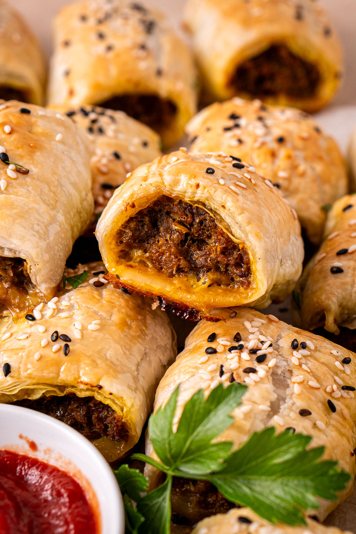 Curried beef sausage rolls with tomato sauce.
