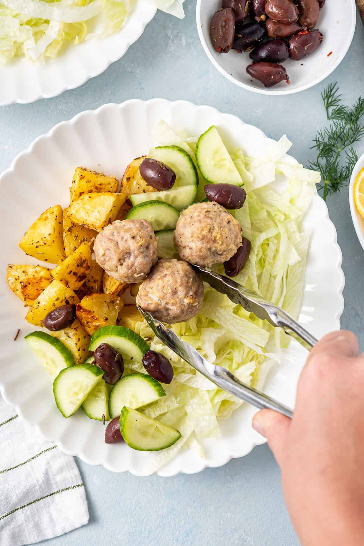 Assembling the meatball bowls.