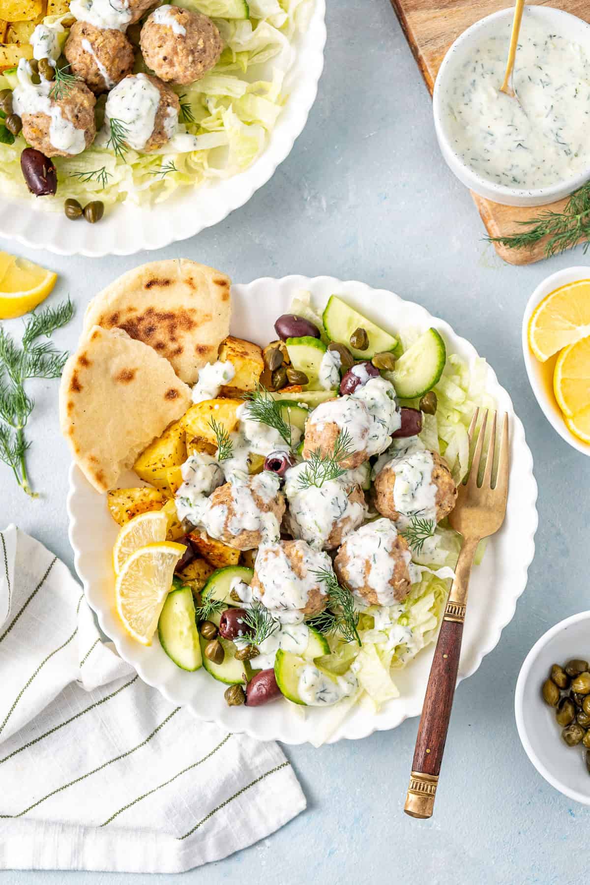 Greek meatball bowls with dairy free tzatziki, lemon and pita bread.