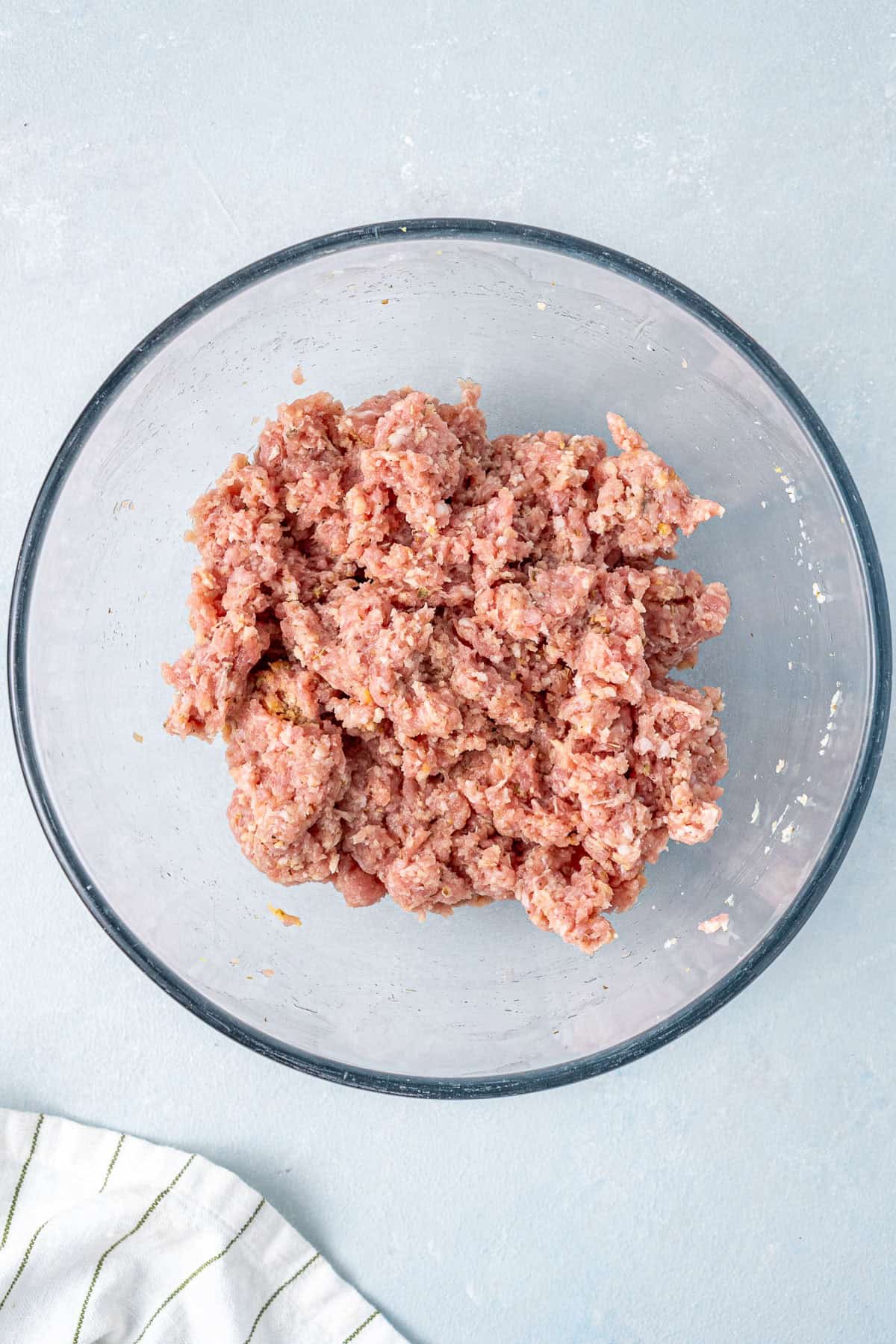 The beef meatball mixture in a glass bowl.