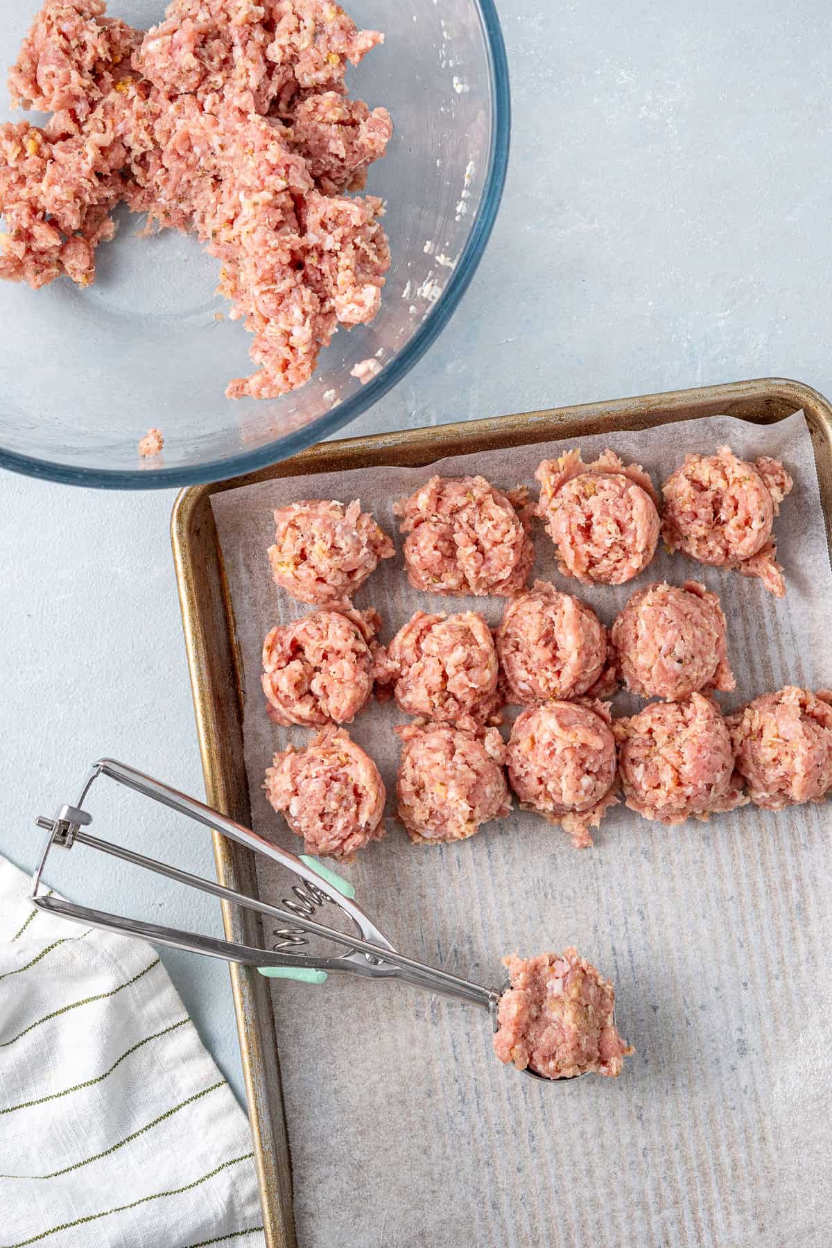 The beef meatball mixture being scooped into balls.