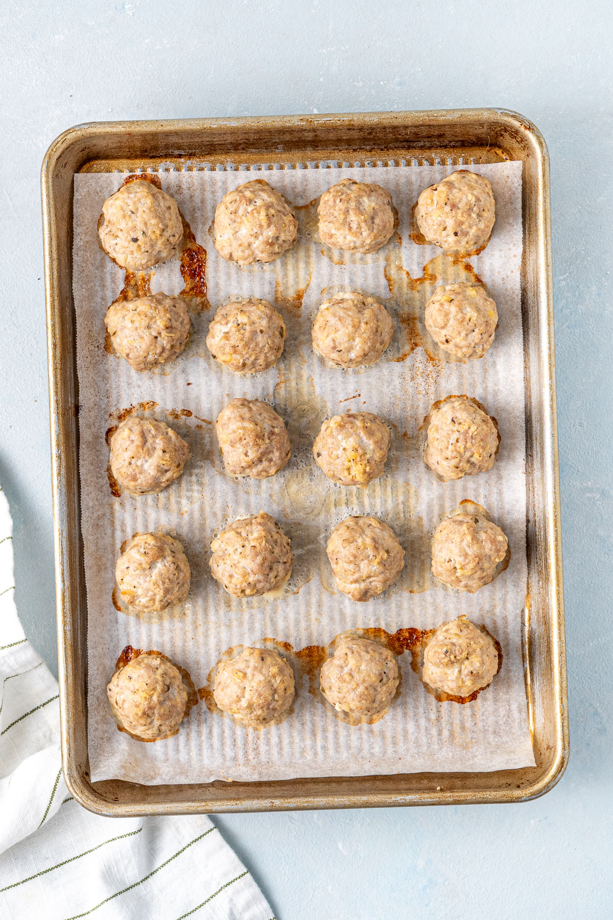 Cooked meatballs on a baking tray.