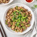 Ground beef fried rice served into bowls with spring onions.