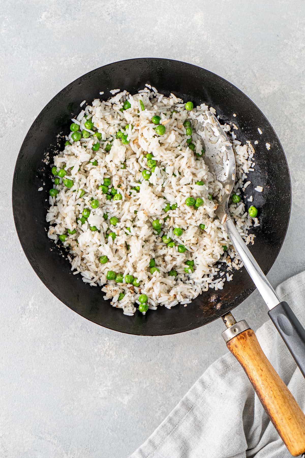 The rice and peas in the wok.