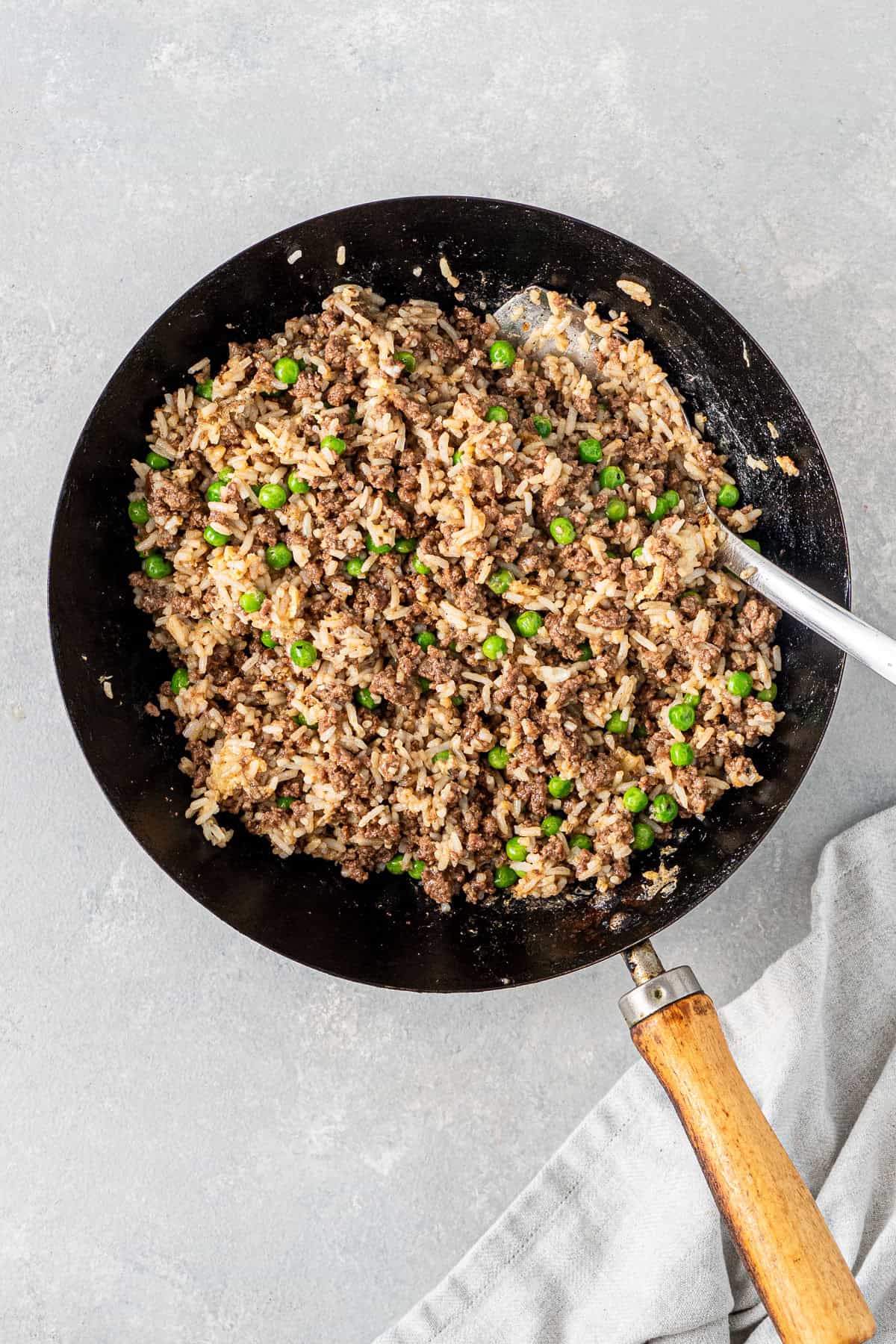 The eggs mixed through the rice and beef in the wok.
