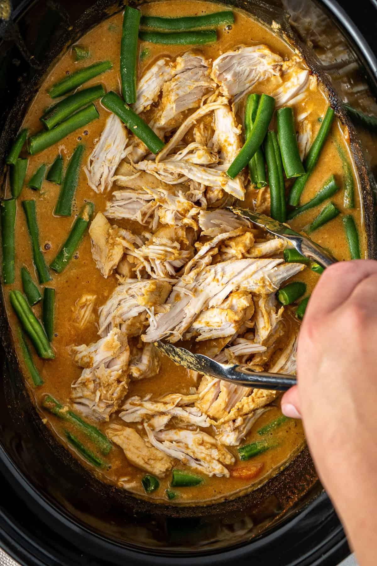 Shredding the chicken and adding the green beans.