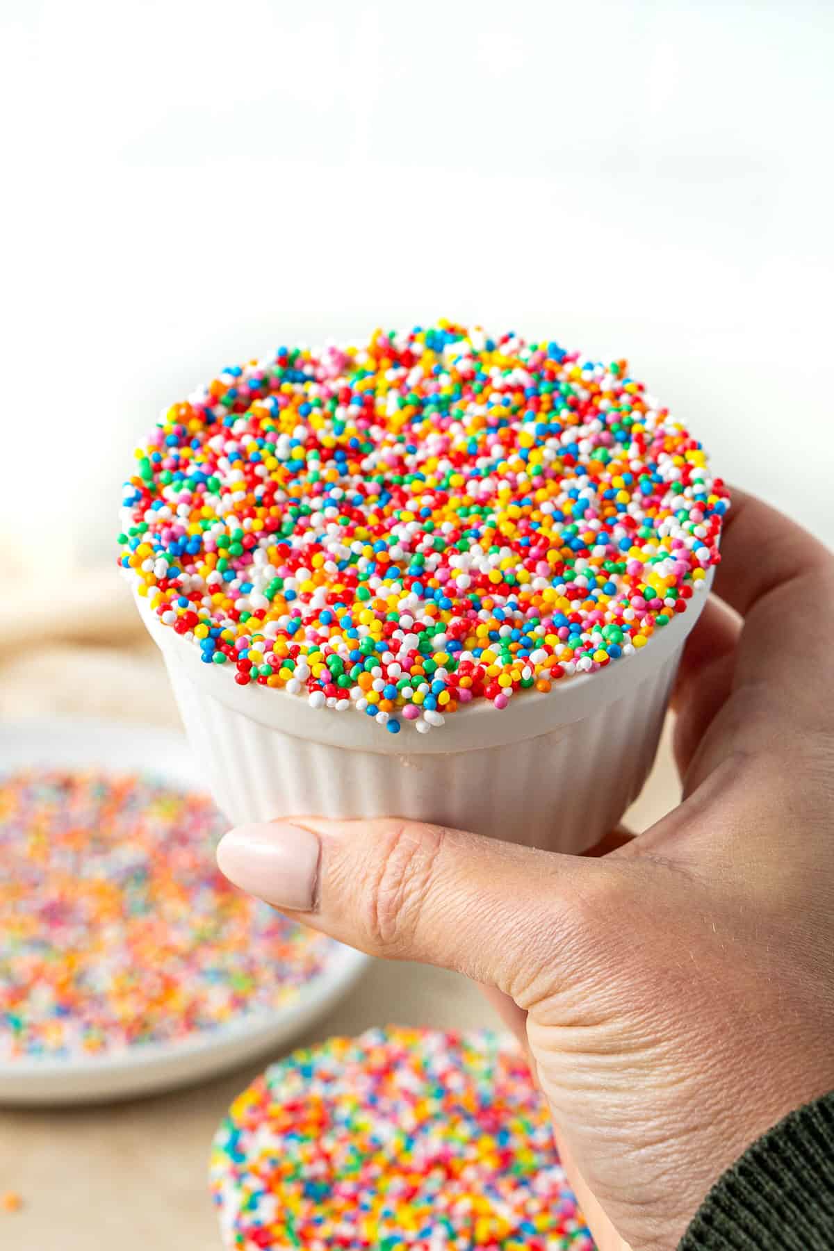 A hand holding a dot cake.