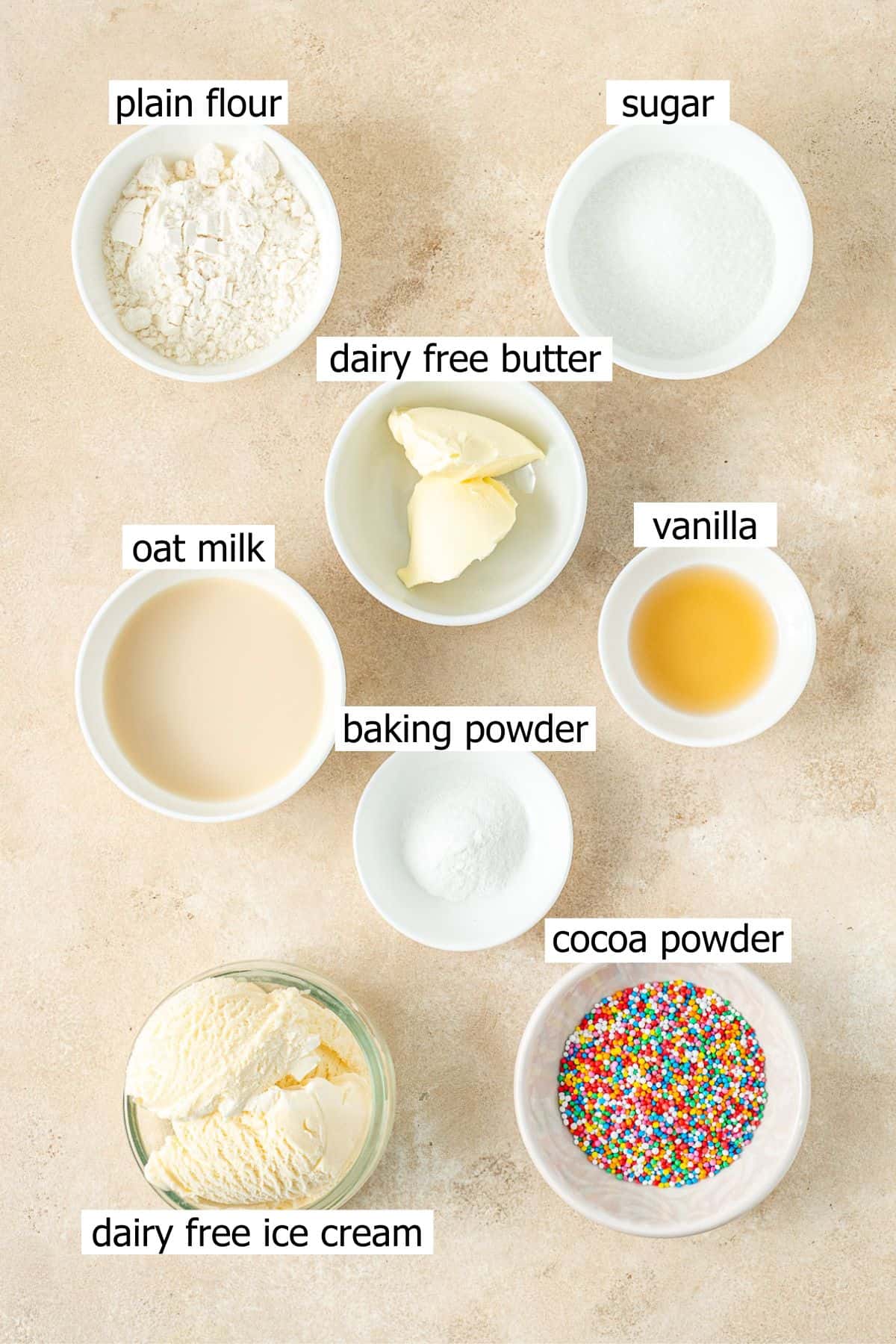 All ingredients needed to make dairy free dot cakes laid out in small bowls.