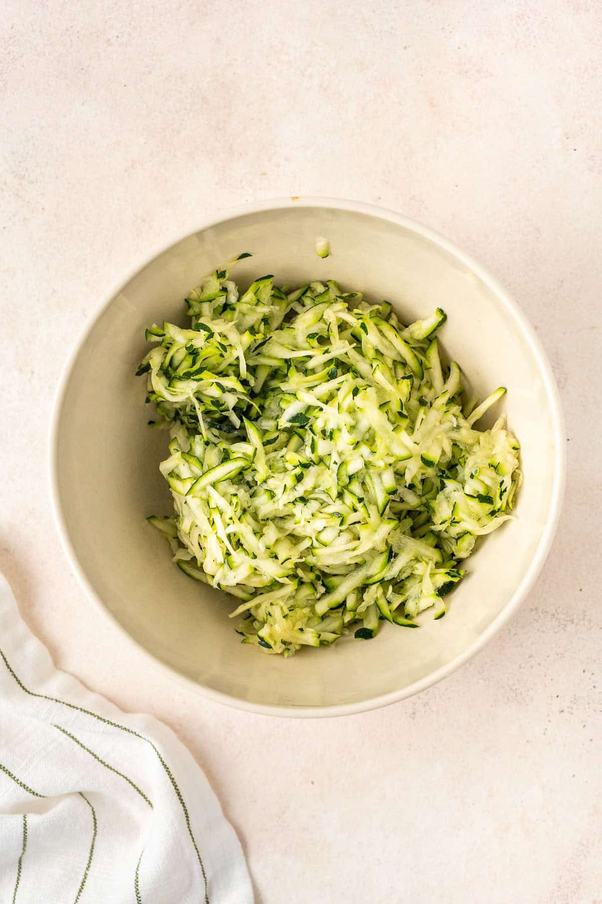 The grated zucchini in a bowl.