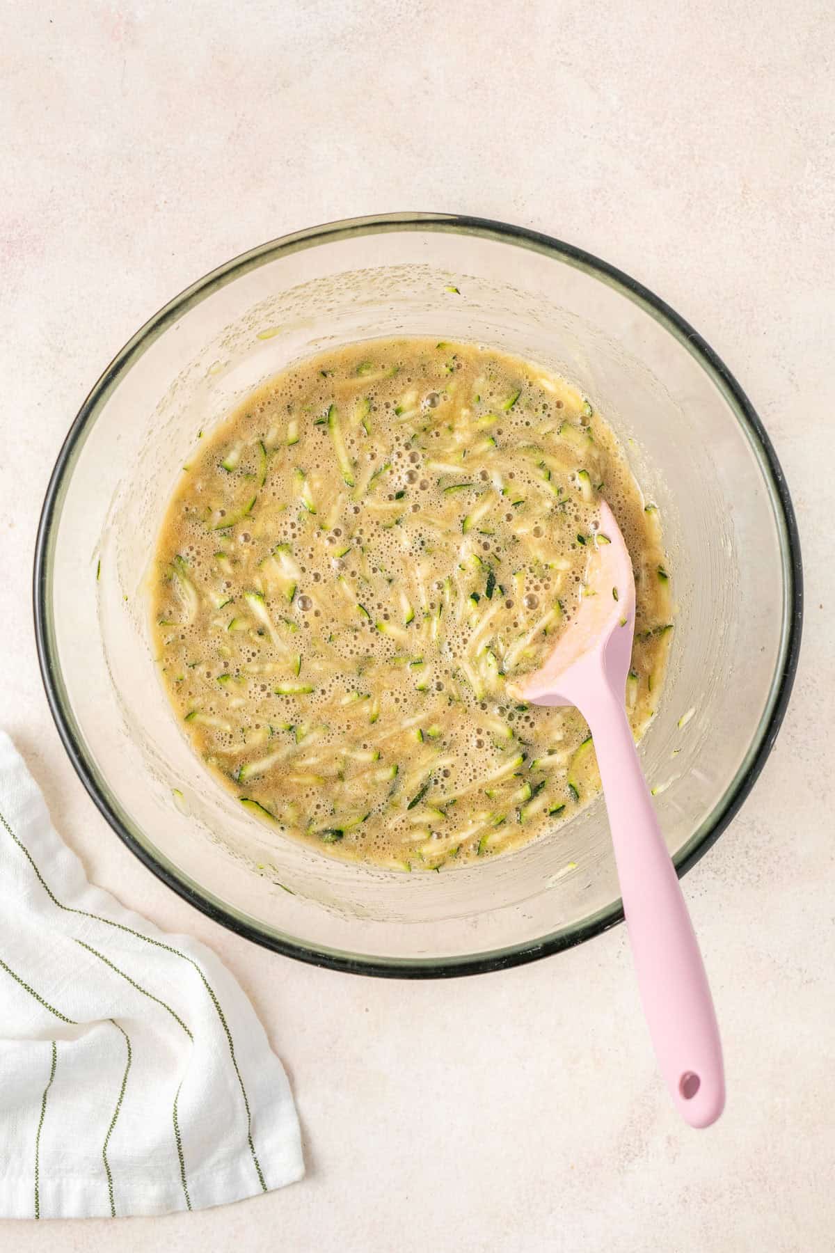 The zucchini mixed through in a glass bowl.
