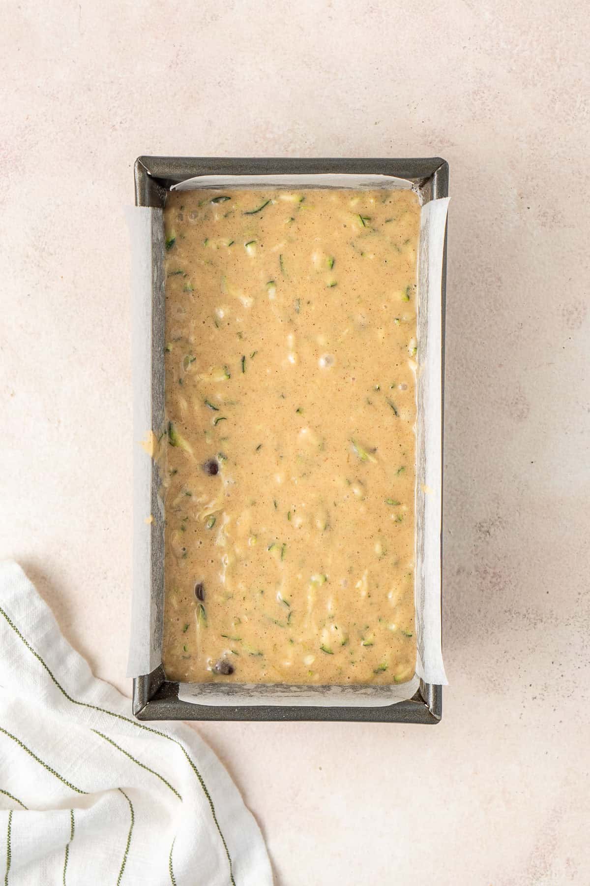 The zucchini bread batter in a loaf pan.