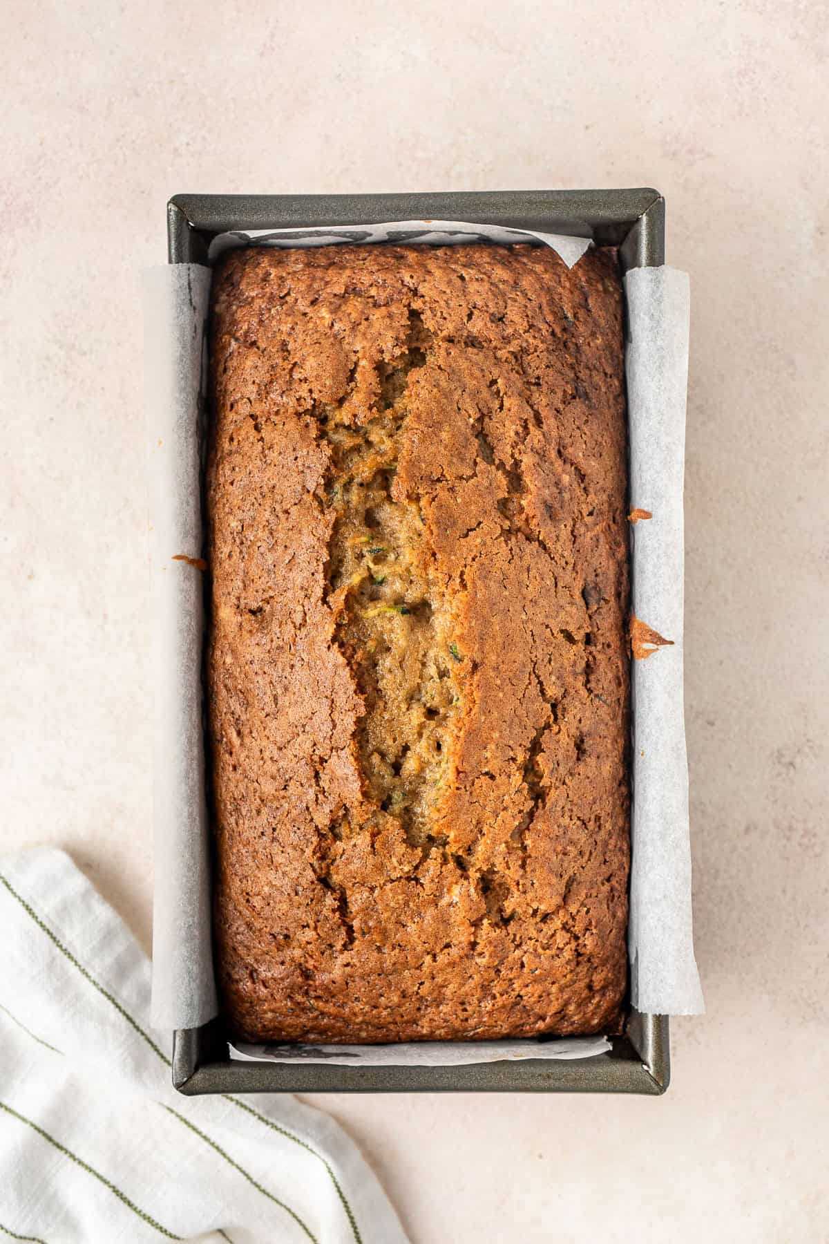 The baked zucchini bread in a loaf pan.