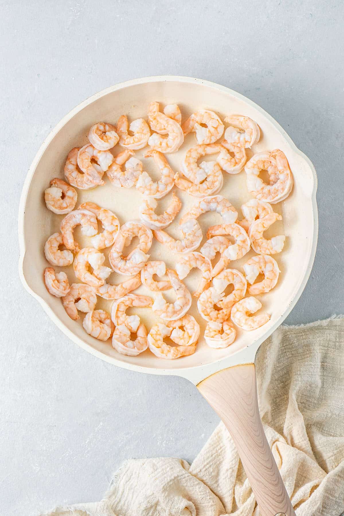 Cooking the prawns in a frying pan.