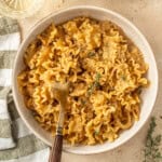 French onion pasta served into bowls with forks.