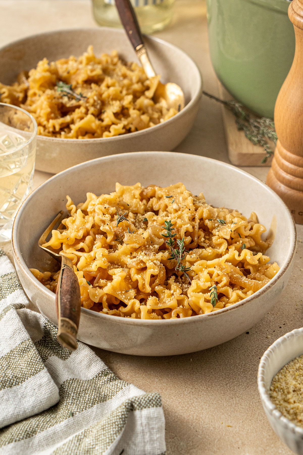 French onion pasta served into bowls with forks.