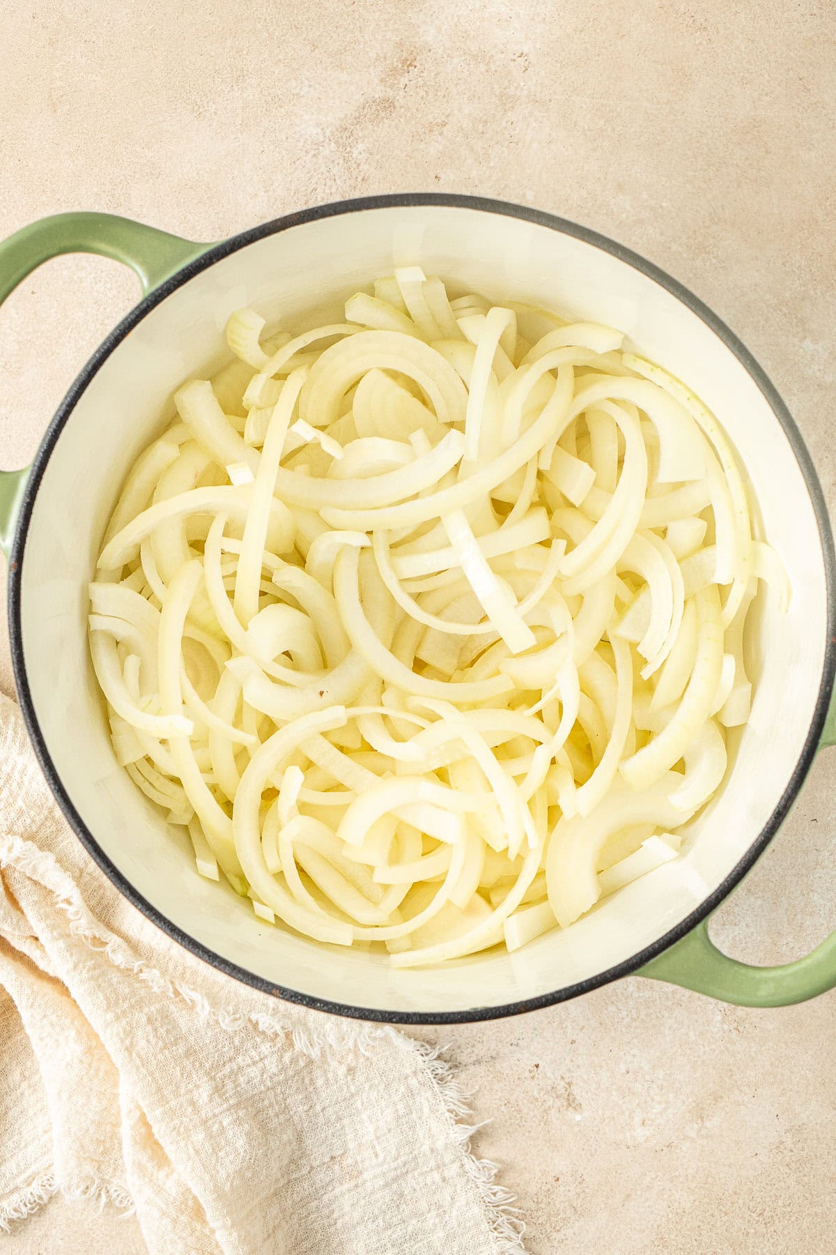 The sliced onions in the pot with the melted butter.