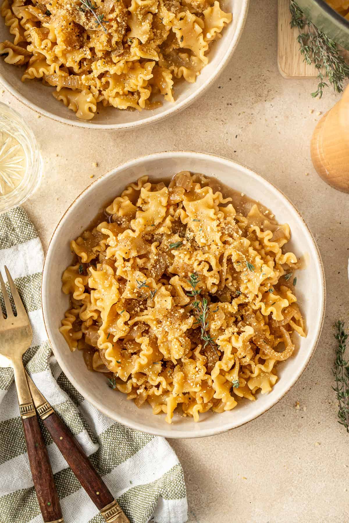 The served french onion pasta in bowls with a fork.