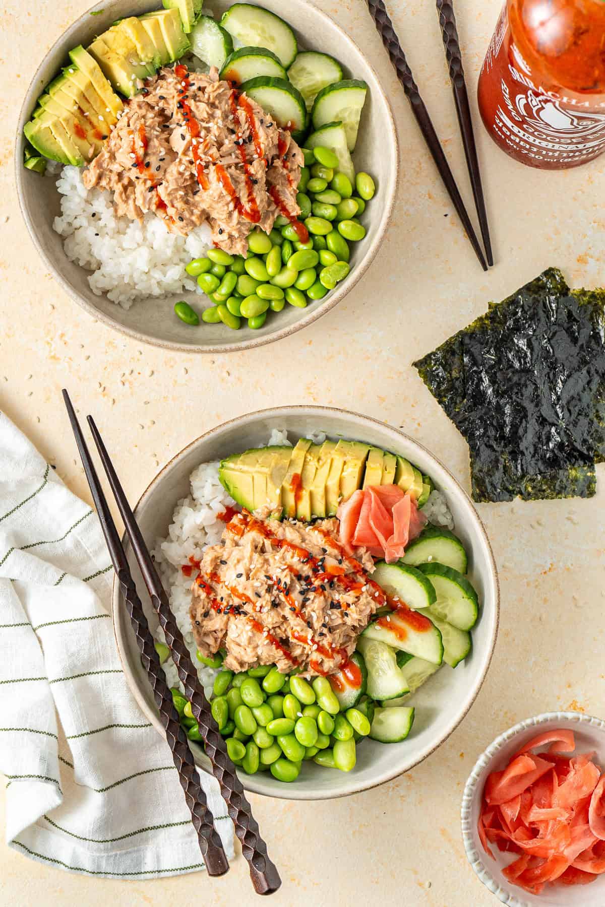 Tuna sushi bowls with avocado and edamame with chopsticks. 