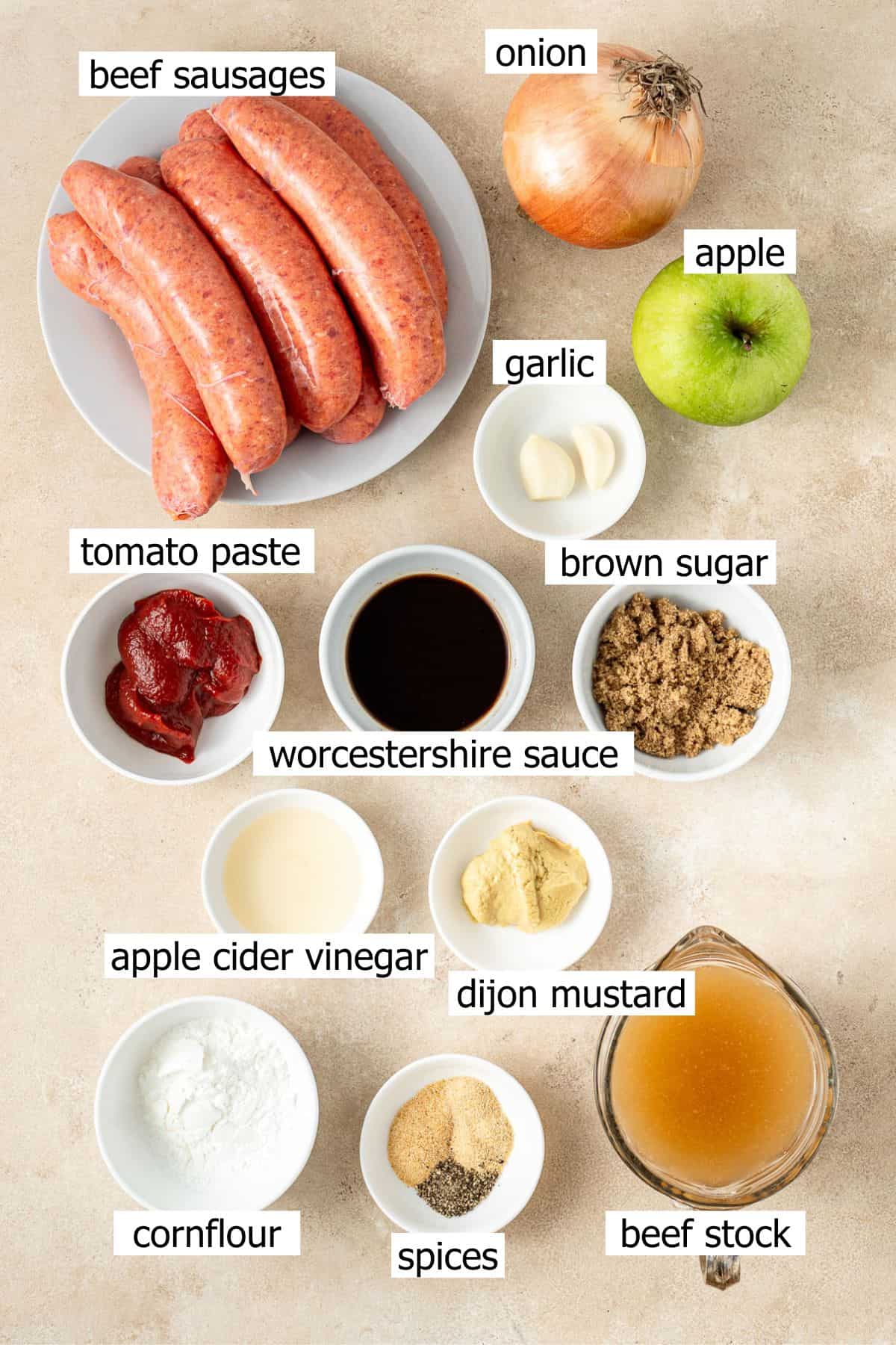 All ingredients needed to make slow cooker devilled sausages in small bowls.