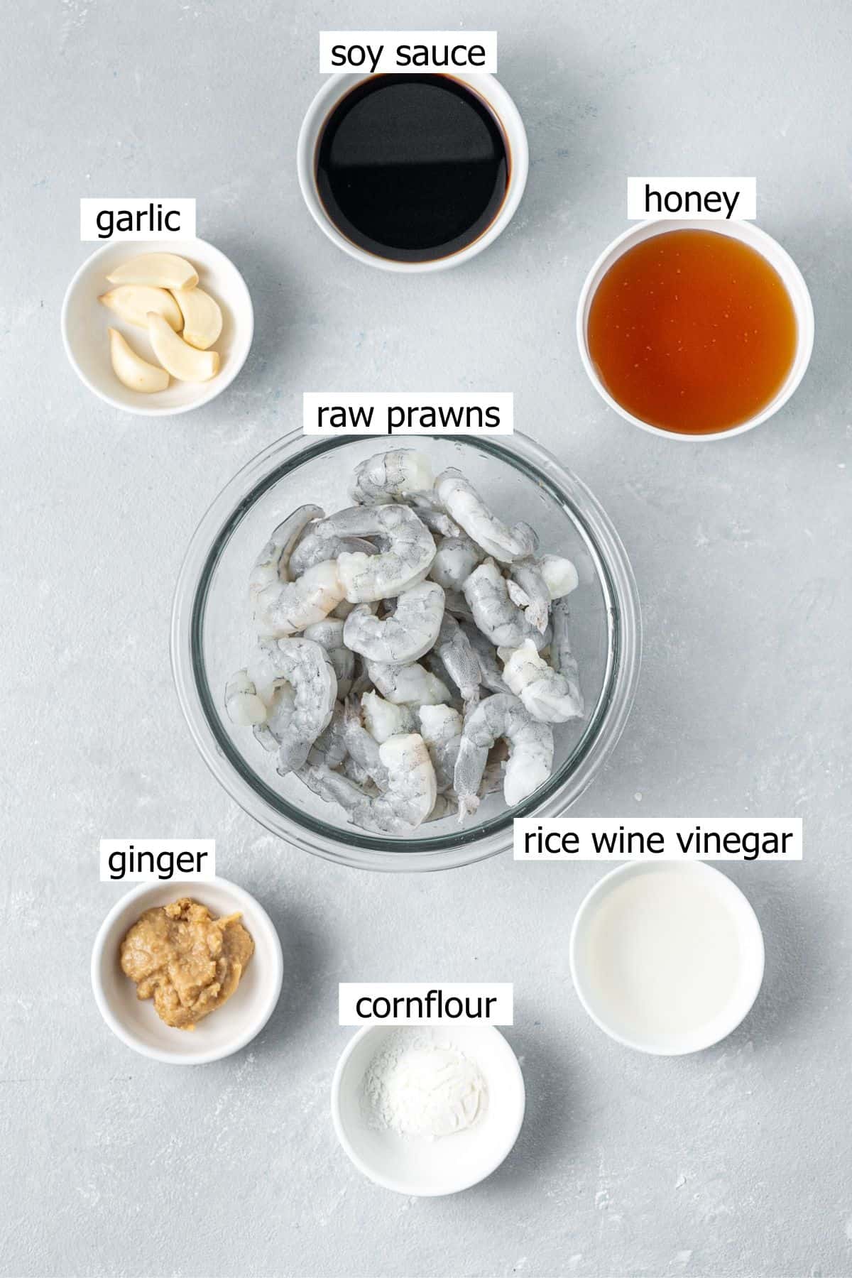 All ingredients needed to make prawn rice bowls laid out in small bowls.