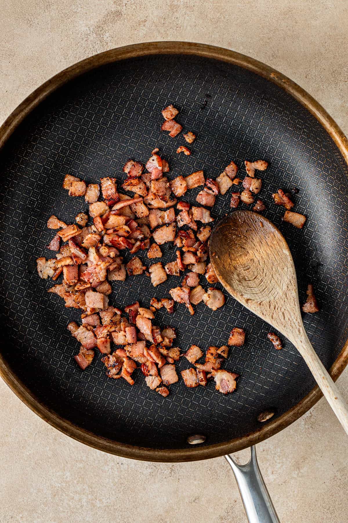 Cooking bacon in a frying pan.