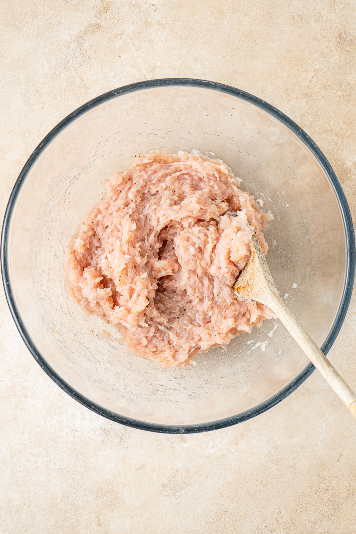 Mixing the chicken mince in a bowl.