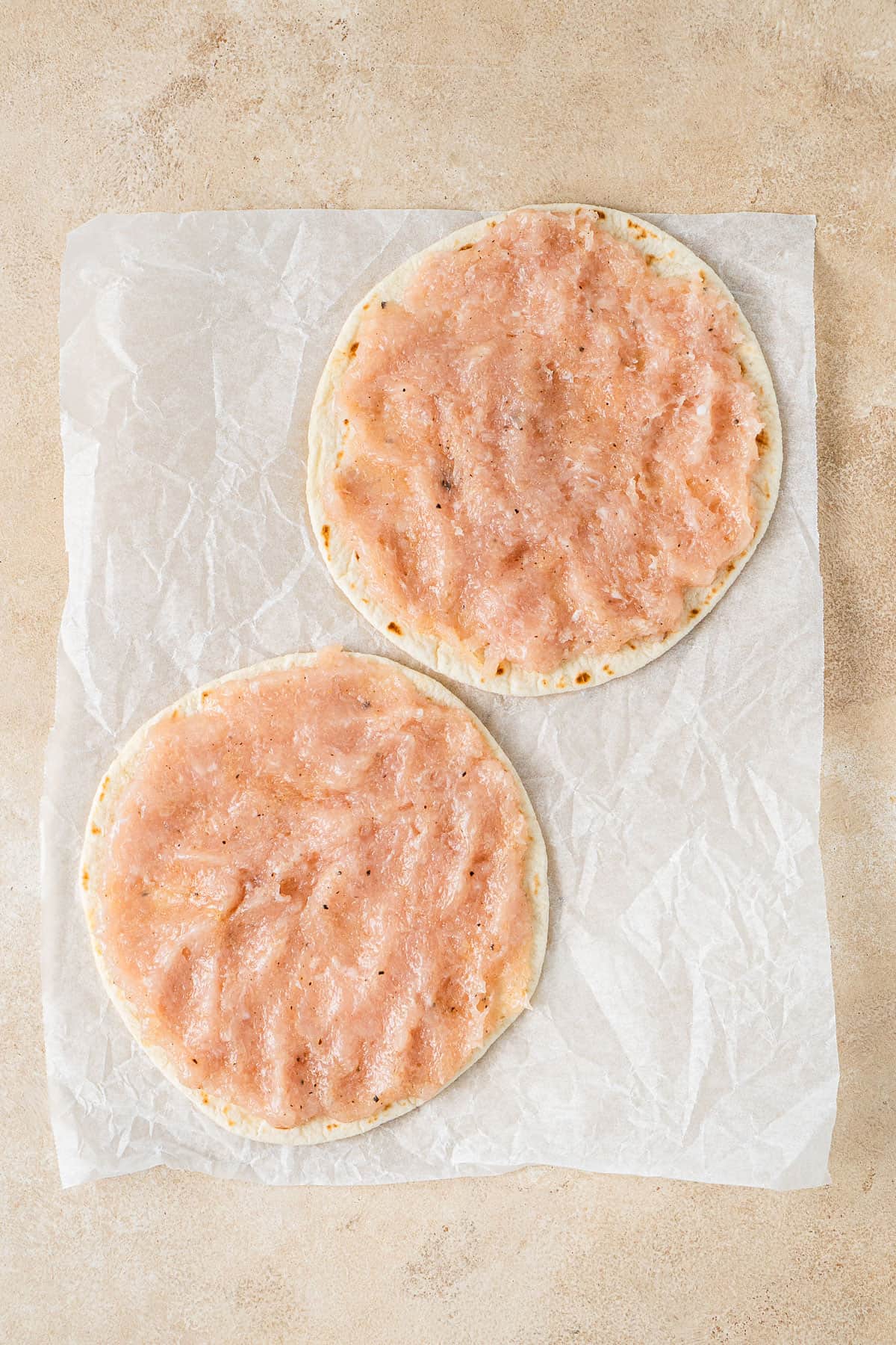 Chicken mince smashed onto a tortilla.