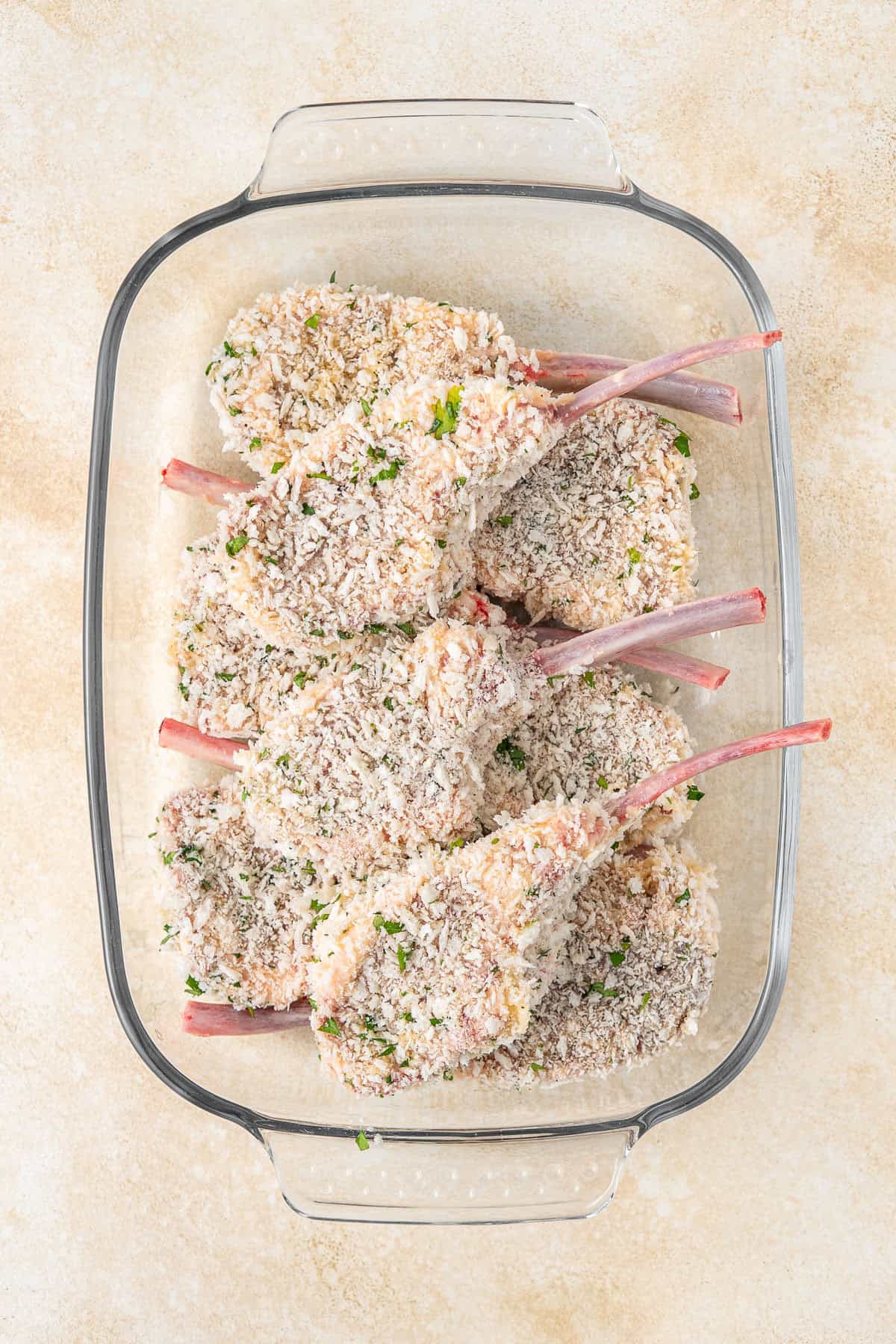 All cutlets crumbed in a dish.