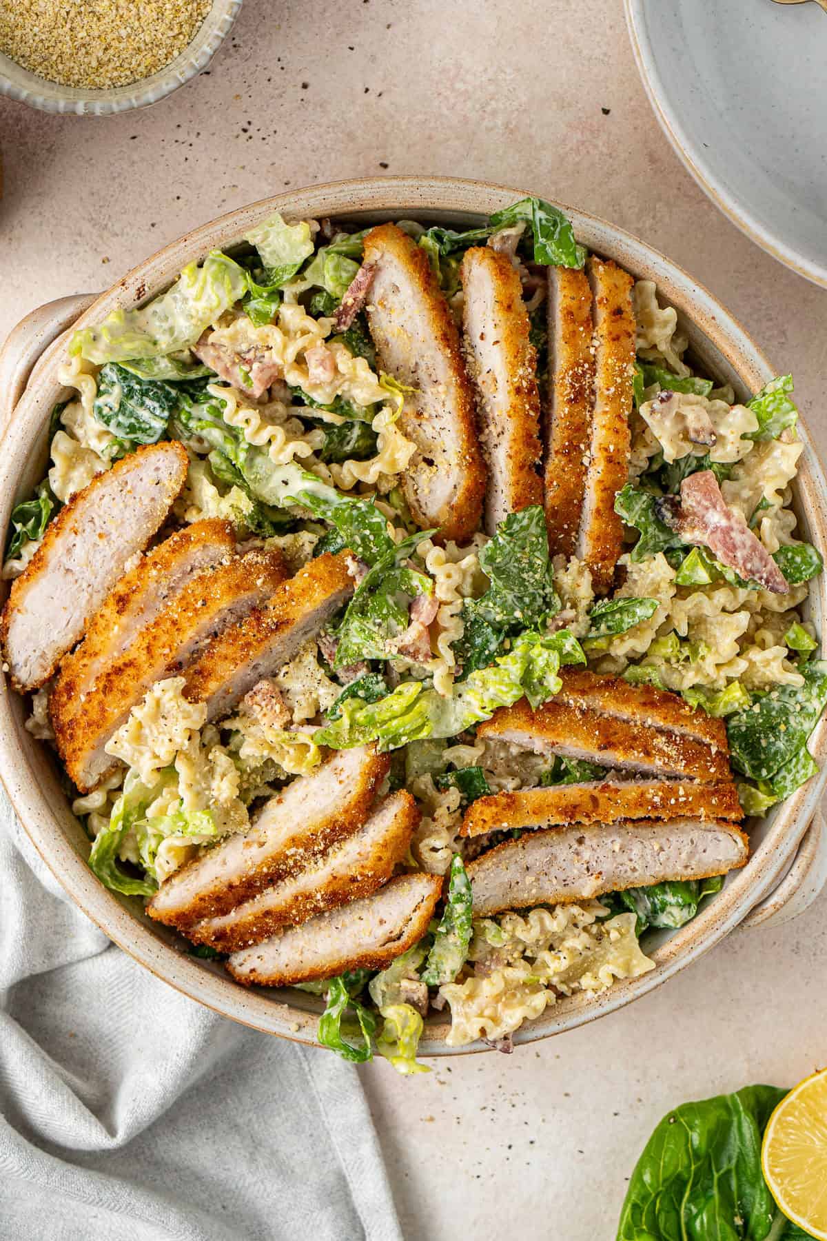 The salad finished with the sliced chicken schnitzel. 