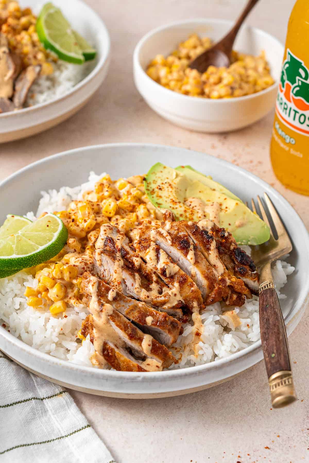 Dairy free street corn chicken rice bowls with a fork.