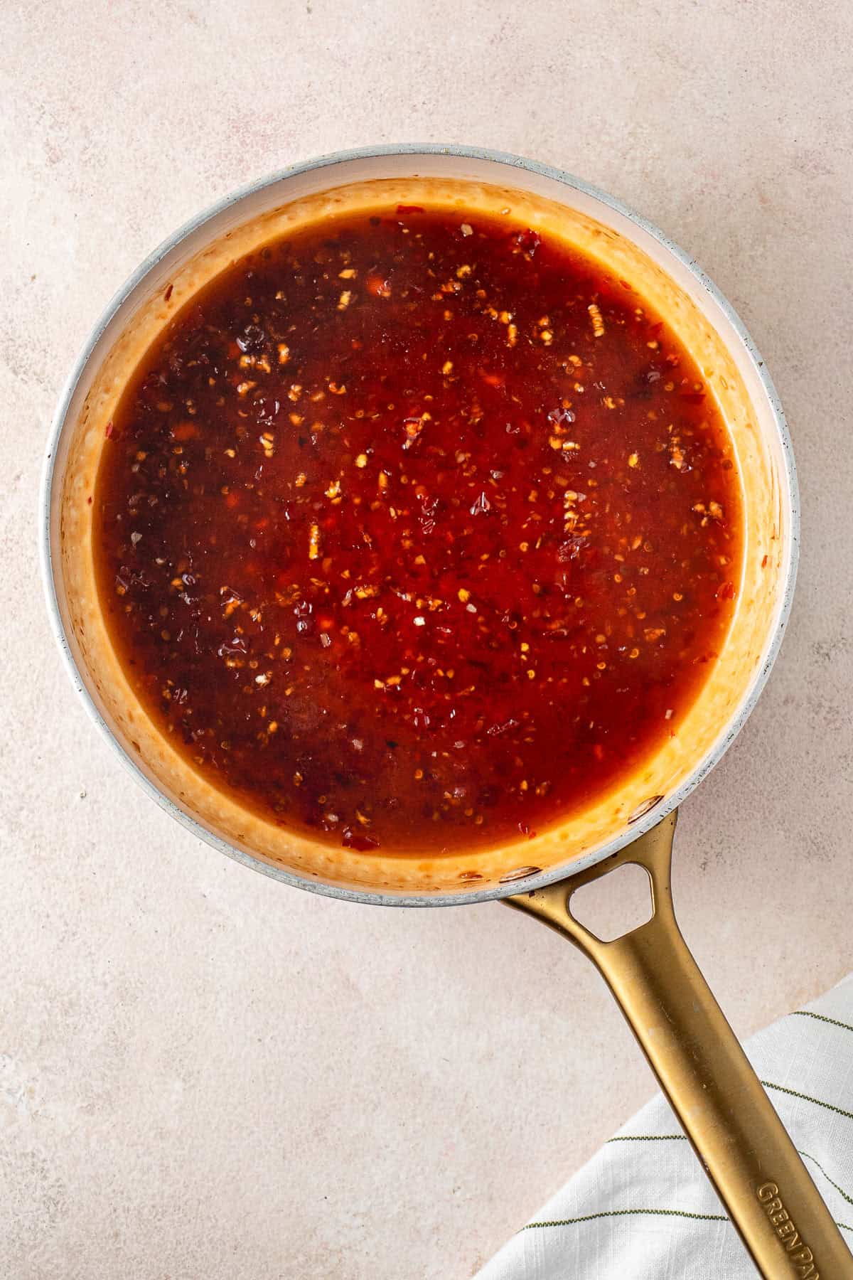 Heating the sauce in a frying pan.