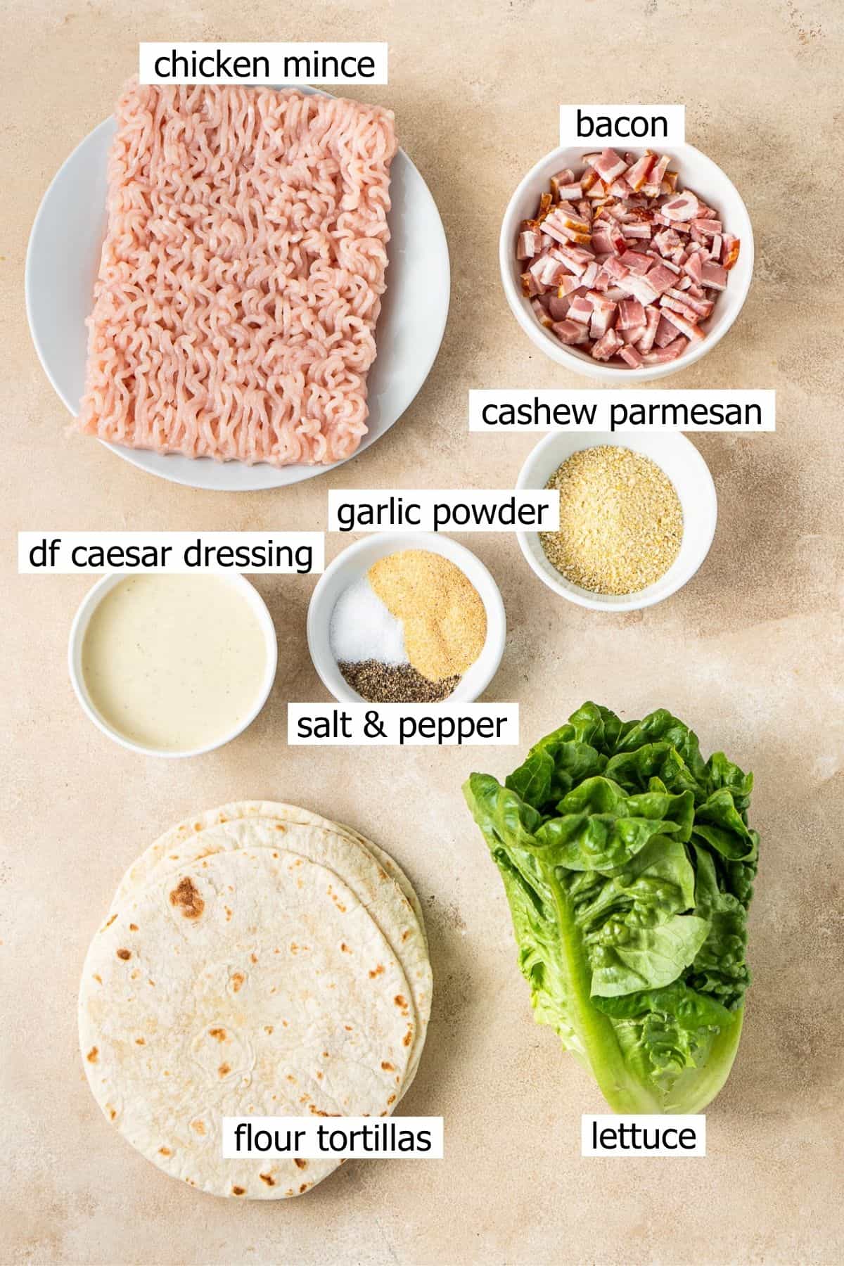 All ingredients needed to make dairy free chicken caesar tacos laid out in bowls.