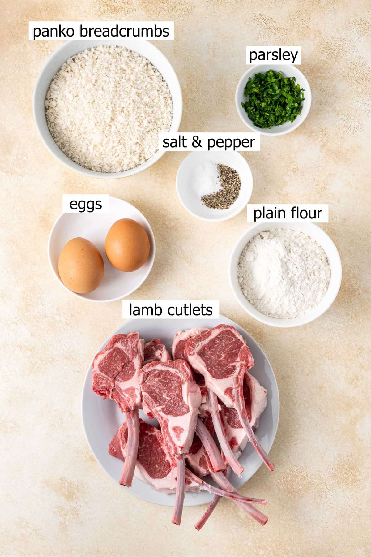 All ingredients needed to make crumbed lamb cutlets laid out in small bowls.
