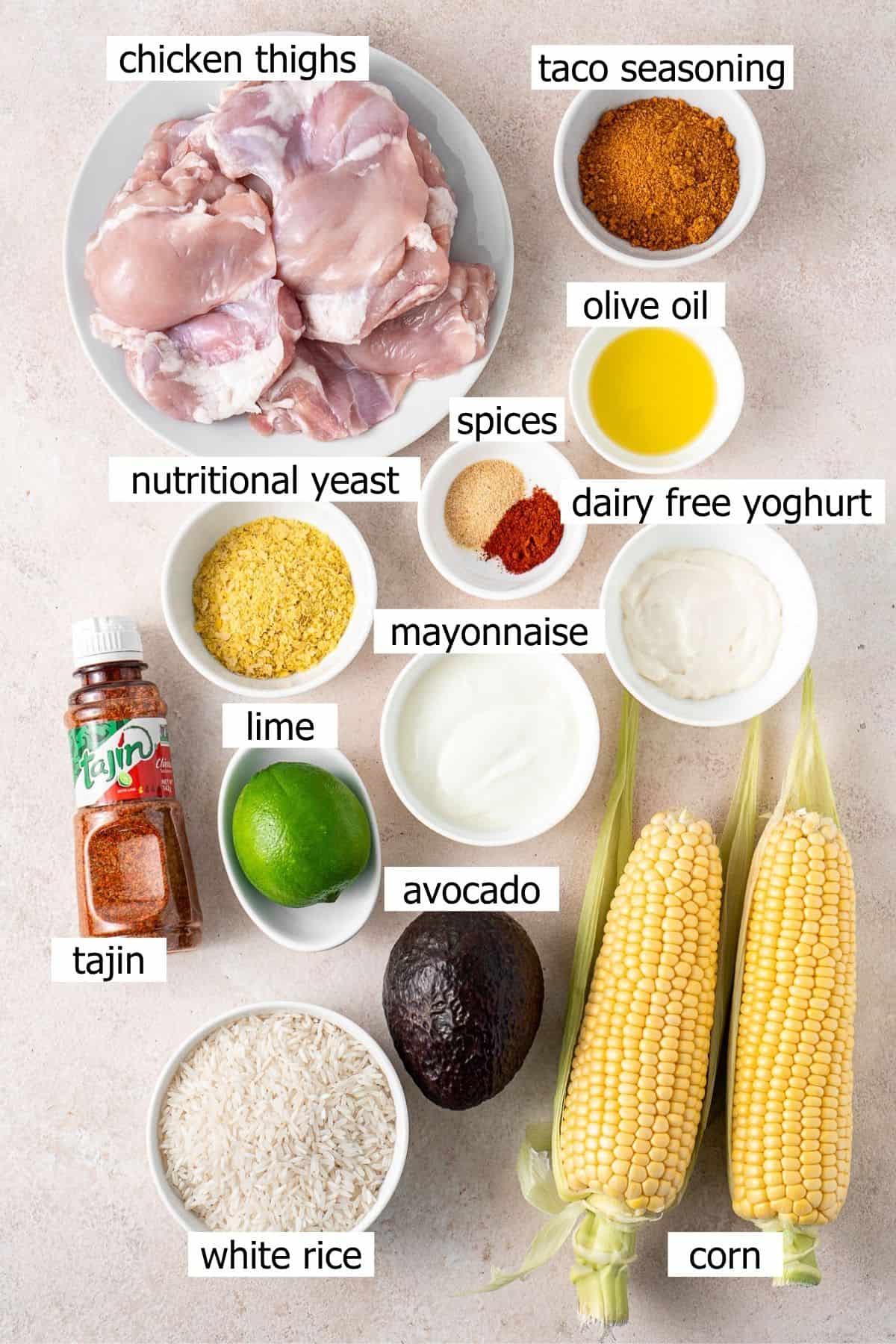 All ingredients needed to make street corn chicken rice bowls laid out in bowls.